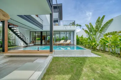 an exterior view of a house with a swimming pool at Luxury Industrial-Style 2BR Villa Kirma Near the Beach in Canggu