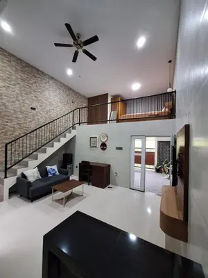 a living room with a couch and a ceiling fan at Home88 Sanur in Sanur