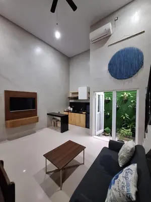 a living room with a couch and a table at Home88 Sanur in Sanur