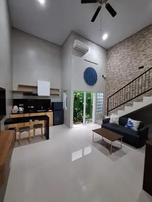 a living room with a couch and a table at Home88 Sanur in Sanur