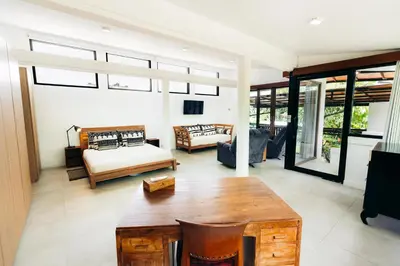 a living room with a couch and a table at Bali Akasa Villa in Seminyak