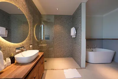 a bathroom with a sink and a bath tub and a tubermott at Twin Villas Drupadi 8BR Seminyak by Exotic Bali Properties in Seminyak