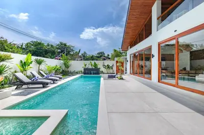 a swimming pool in the backyard of a house at The Aurum Canggu Villas by Nagisa Bali in Canggu