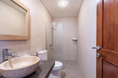 a bathroom with a sink and a toilet at Villa Azure 3 - Tropical 4-Bedroom Pool Villa Near Seminyak in Seminyak