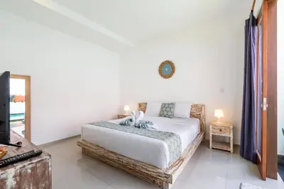 a bedroom with a bed and a clock on the wall at Villa Azure 3 - Tropical 4-Bedroom Pool Villa Near Seminyak in Seminyak