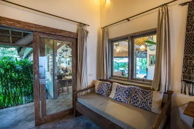 a living room with a couch and a window at Villa Damai Manis in Seminyak