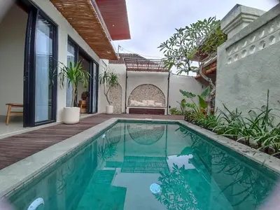 a swimming pool in the backyard of a house at Villa Juanjo Sanur in Sanur