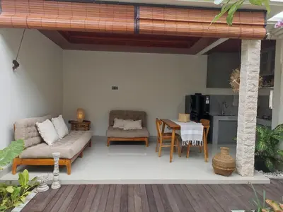 a living room with a couch and a table at Villa Juanjo Sanur in Sanur