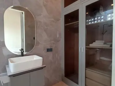 a bathroom with a sink and a mirror at Villa Juanjo Sanur in Sanur