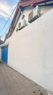 a white wall with two air conditioners on top of it at Santorini House in Bali Near Airport in Kuta
