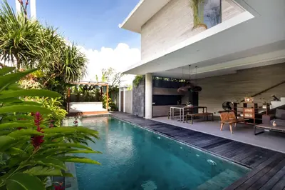a swimming pool in the backyard of a house at Swan Villa R in Seminyak