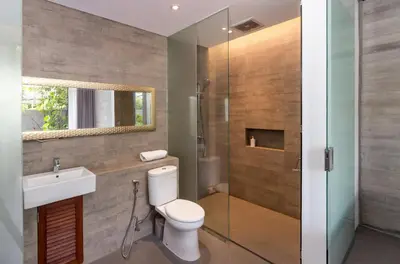 a bathroom with a toilet and a sink and a shower at Swan Villa R in Seminyak