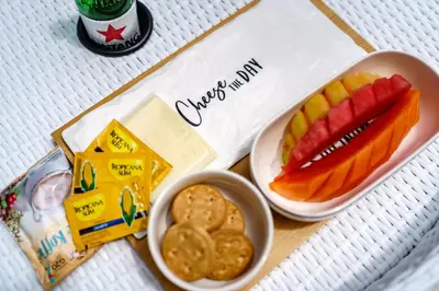 a tray with a bowl of crackers and a plate of fruit at Tropical Villas - 2 Bed & 3 Bed in Kerobokan