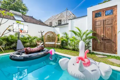 a house with a swimming pool with an inflatable pool toy at 3Br New Private Family Villa- Sanur in Sanur