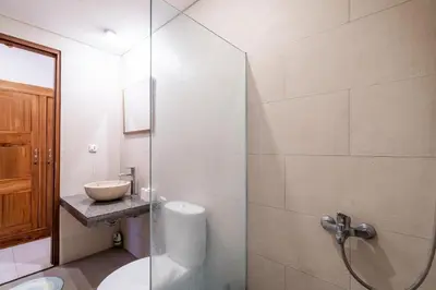 a bathroom with a glass shower and a sink at Villa Azure 3 - Private Suite in Shared Tropical Pool Villa in Seminyak