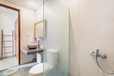 a bathroom with a toilet and a sink at Villa Azure 3 - Private Suite in Shared Tropical Pool Villa in Seminyak