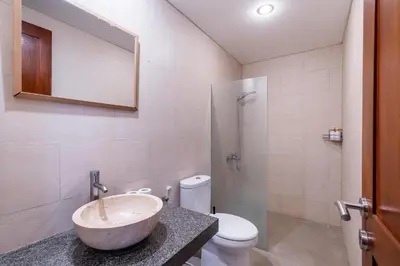 a bathroom with a sink and a toilet at Villa Azure 3 - Private Suite in Shared Tropical Pool Villa in Seminyak