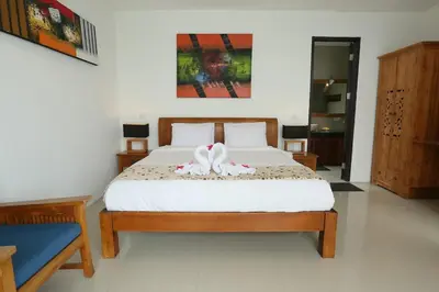 a bedroom with a bed with a white bedspread at Villa Stephana Edge of Seminyak in Canggu