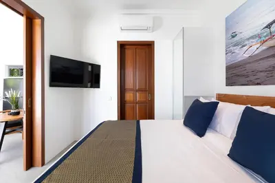 a bedroom with a bed and a tv on a wall at Gorgeous 1 Bed Pool Villa, Walk to Beach, Shops in Seminyak