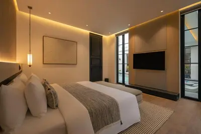 a bedroom with a large bed and a television at Marvee Villa Bali in Canggu