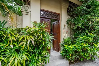 a front door of a house with lots of plants at Just a 3 min stroll to the Seminyak beach in Badung