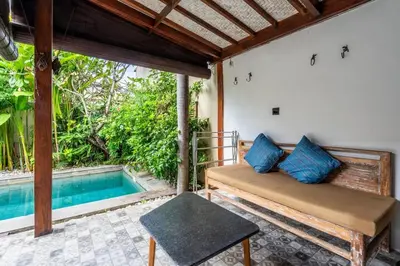 a room with a bed and a swimming pool at Just a 3 min stroll to the Seminyak beach in Badung