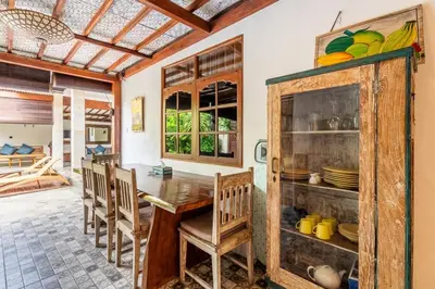 a dining room with a wooden table and chairs at Just a 3 min stroll to the Seminyak beach in Badung