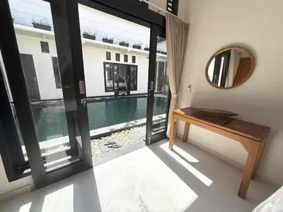 a room with a view of a pool and a mirror at Villa KAS Legian Seminyak - 6 Bedroom Villa in Seminyak