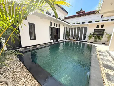 a swimming pool in the backyard of a house at Villa KAS Legian Seminyak - 6 Bedroom Villa in Seminyak
