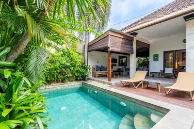 a villa with a swimming pool and a house at 3-Bedroom Villa near Kudeta Beach - Oberoi Street By iBali Management in Seminyak