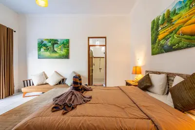 a bedroom with a bed and a living room at 3-Bedroom Villa near Kudeta Beach - Oberoi Street By iBali Management in Seminyak