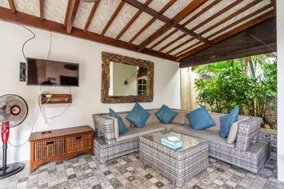 a living room with a couch and blue pillows at 3-Bedroom Villa near Kudeta Beach - Oberoi Street By iBali Management in Seminyak