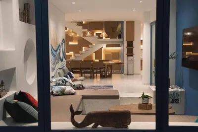 a living room with a cat sitting on a couch at Stunning Sea Front Villa 4BR Nusa Dua in Badung