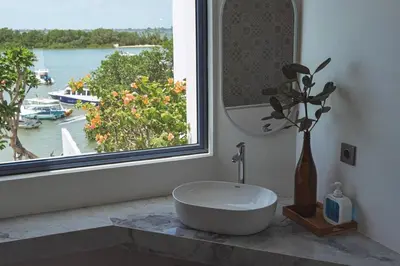a bathroom with a sink and a window with a view at Stunning Sea Front Villa 4BR Nusa Dua in Badung