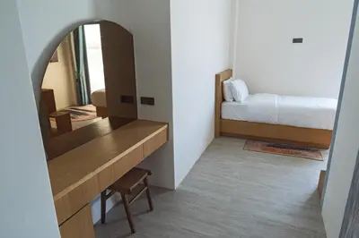 a bedroom with a bed and a mirror at Stunning Sea Front Villa 4BR Nusa Dua in Badung