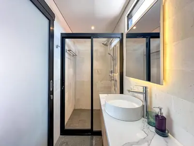 a bathroom with a sink and a shower at Olala Loft Seminyak in Seminyak