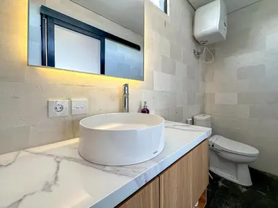 a bathroom with a sink and a toilet at Olala Loft Seminyak in Seminyak