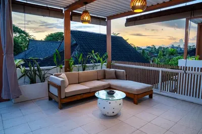 a couch and a coffee table on a balcony at 5BR Private Pool Villa - 1 min Beach - Daily Staff, Private Pool, Gym & Games in Canggu