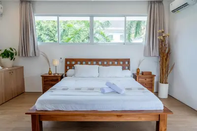 a bedroom with a large bed with two towels on it at 5BR Private Pool Villa - 1 min Beach - Daily Staff, Private Pool, Gym & Games in Canggu
