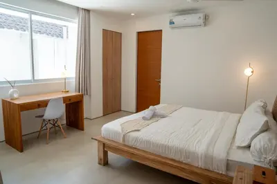 a bedroom with a bed and a desk and a desk at 5BR Private Pool Villa - 1 min Beach - Daily Staff, Private Pool, Gym & Games in Canggu
