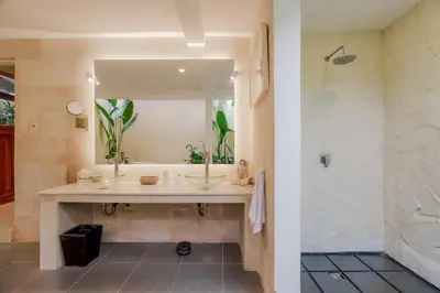 a bathroom with a sink and a large mirror at Villa Taman Rahasia, Sitara Villa Group in Seminyak