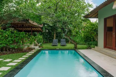 a swimming pool in the backyard of a house at Villa Taman Rahasia, Sitara Villa Group in Seminyak