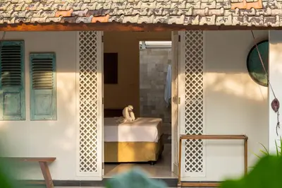 a room with a bed and a table at Tropical Oasis of Calm in the Heart of Seminyak, 4BR Villa Luisha in Seminyak