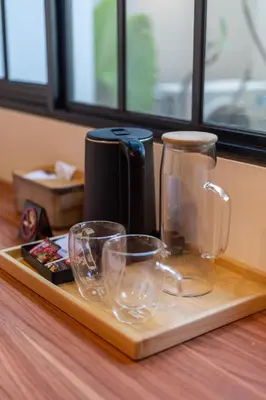 a tray with glasses on a table with a coffee maker at Villa Loema in Kerobokan