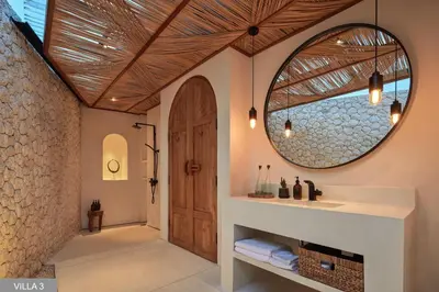 a bathroom with a sink and a mirror at Villa Massilia Bali in Seminyak