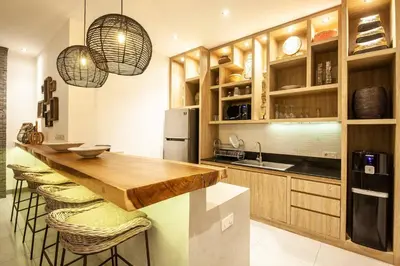 a kitchen with wooden cabinets and a wooden counter top at Modern 4bd villa, amazing location in Seminyak in Seminyak