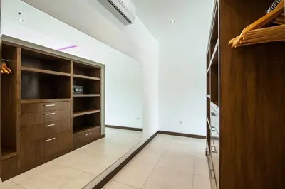 a large kitchen with wooden cabinets and a tv at Seminyak Luxueuse villa 61 BR 18 personnes in Seminyak