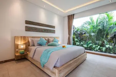 a bedroom with a large bed with a large window at Seminyak Luxueuse villa 2 chambres in Seminyak