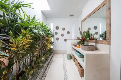 a bathroom with plants and a mirror at Seminyak Luxueuse villa 2 chambres in Seminyak