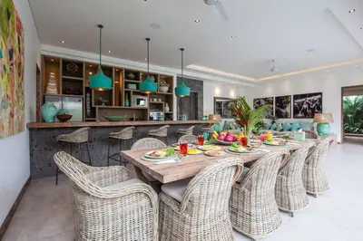 a dining room with a long table and chairs at Seminyak Luxueuse villa 2 chambres in Seminyak